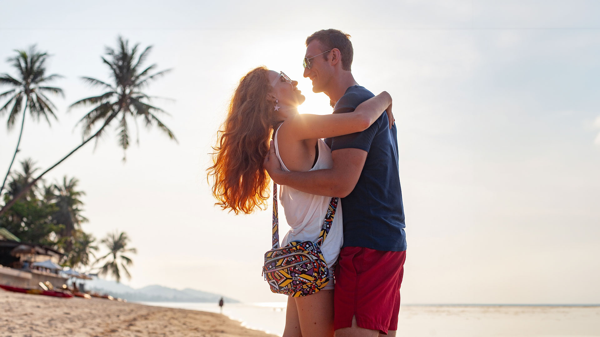 Newlywed couple embracing at sunset on a beach in Marathon, Florida, celebrating their honeymoon